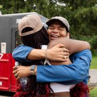 Two africana students hugging